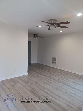 Long Beach apartment for rent - a living room with white walls and a ceiling fan