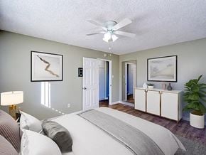 Bellflower apartment for rent - A bedroom with a large bed and a ceiling fan.
