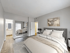 Anaheim apartment for rent - A bedroom with a large bed and a painting on the wall.