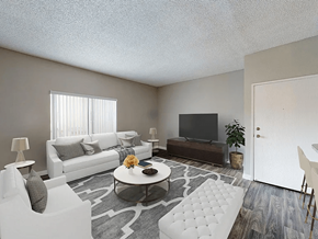 Anaheim apartment for rent - A living room with a white couch, a grey rug, and a television.