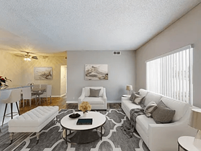 Anaheim apartment for rent - A living room with a white couch, a coffee table, and a rug.