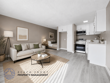 Whittier apartment for rent - A modern living room with a coffee table and a kitchen area in the background.
