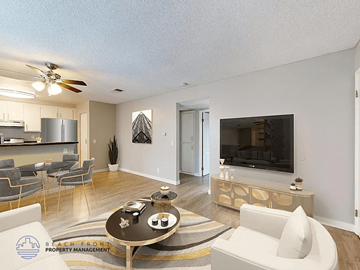 Paramount apartment for rent - A living room with a television, a sofa, and a coffee table.
