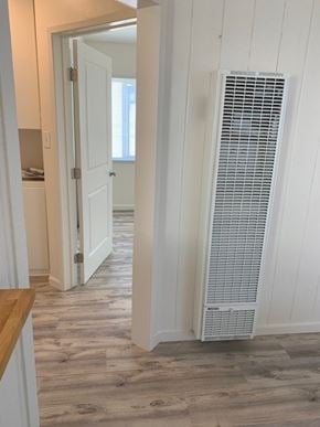 Hermosa Beach apartment for rent - A white air conditioner is on the wall in a room with wood flooring.