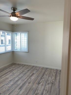 Hermosa Beach apartment for rent - A room with a ceiling fan and a window with blinds.