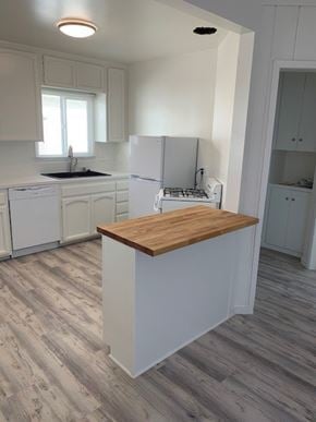 Hermosa Beach apartment for rent - A kitchen with a white fridge and a wooden counter.