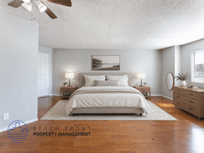 Whittier apartment for rent - A bedroom with a large bed, two nightstands, and a ceiling fan.