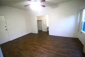 Wilmington apartment for rent - an empty living room with wood floors and a ceiling fan