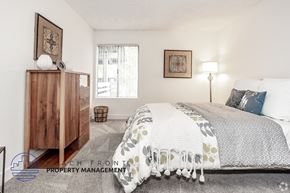 Westminster apartment for rent - A bedroom with a bed, nightstand, and a wooden dresser.