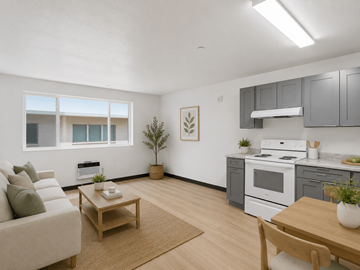 Honolulu apartment for rent - A living room with a couch, a table, and a kitchen area in the background.