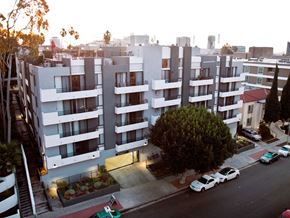 Los Angeles apartment for rent - an aerial view of an apartment building with cars parked in front