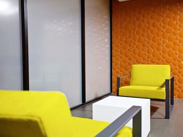 Los Angeles apartment for rent - a living room with yellow chairs and a white table
