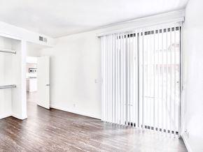 Hollywood apartment for rent - an empty living room with a sliding glass door