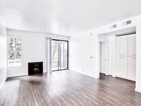 Hollywood apartment for rent - an empty living room with white walls and a fireplace