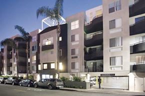 Los Angeles apartment for rent - an apartment building with cars parked in front of it