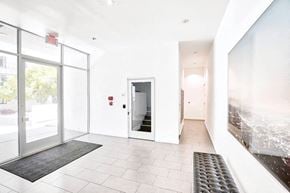 Hollywood apartment for rent - the entrance of a building with white walls and glass doors