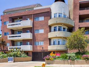 Los Angeles apartment for rent - a building with three balconies and a sign in front of it