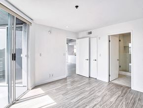 Los Angeles apartment for rent - an empty living room with sliding glass doors to a bathroom