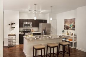 Longmont apartment for rent - a kitchen with a marble counter top and stools