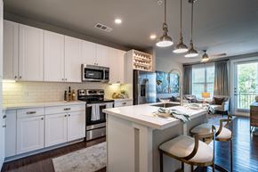 Dallas apartment for rent - A modern kitchen with white cabinets and a large island.