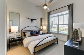 Celina apartment for rent - a bedroom with a large bed and a ceiling fan