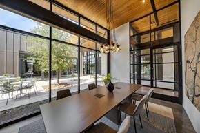 Houston apartment for rent - a conference room with large windows and a wooden ceiling