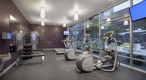 Longmont apartment for rent - a gym with weights and a large window
