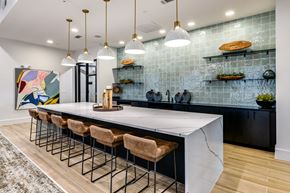 Celina apartment for rent - a large kitchen with a marble counter top and bar stools