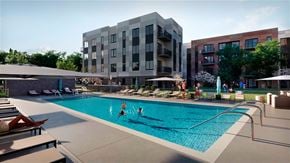 Skokie townhouse for rent - A swimming pool with people in it and apartment buildings in the background.