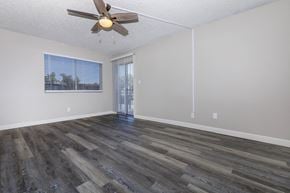 Glendale apartment for rent - an empty living room with a ceiling fan and a window