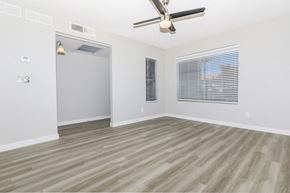Las Vegas apartment for rent - an empty living room with a ceiling fan and a window