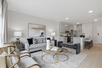 Glenview apartment for rent - A modern living room with a grey sofa, a coffee table, and a painting on the wall.
