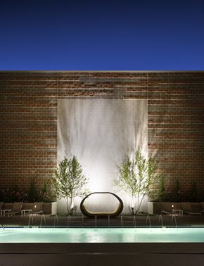Longmont apartment for rent - a pool with a chair in front of a brick wall