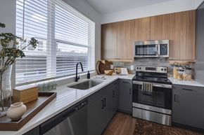Houston apartment for rent - a kitchen with gray cabinets and white countertops