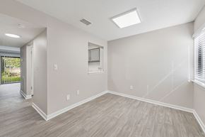 Hillsborough townhouse for rent - A spacious room with light wood flooring and white walls.