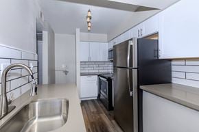 Glendale apartment for rent - an empty kitchen with stainless steel appliances and white cabinets