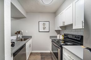 Smyrna apartment for rent - an apartment kitchen with stainless steel appliances and white cabinets