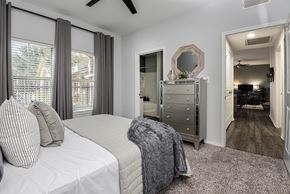 Arlington apartment for rent - a bedroom with a bed and a dresser and a mirror