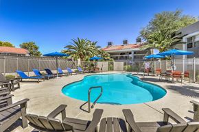 Las Vegas apartment for rent - our resort style swimming pool is surrounded by chairs and umbrellas