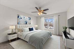 Grayslake apartment for rent - a bedroom with a bed and a ceiling fan