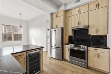 Dallas apartment for rent - A kitchen with wooden cabinets and a marble countertop.