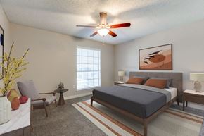 Dallas apartment for rent - a bedroom with a bed and a ceiling fan