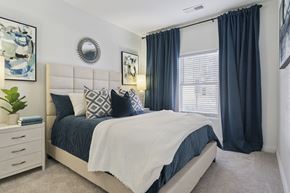 Lone Tree apartment for rent - A bedroom with a large bed and a white headboard.