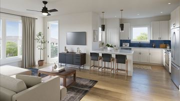 Richmond apartment for rent - A modern kitchen with a bar area and a living room area.