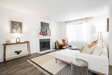 Dallas apartment for rent - a living room with a white couch and a fireplace