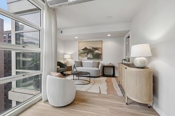 Washington apartment for rent - A living room with a white chair and a white lamp.