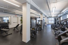 Omaha apartment for rent - A gym with a variety of equipment including treadmills, weights, and exercise machines.