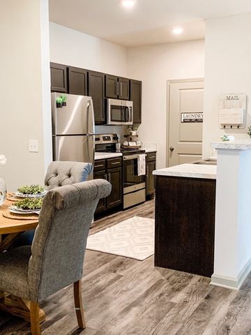 Columbia apartment for rent - a kitchen with stainless steel appliances and a dining table