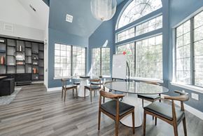 Dallas apartment for rent - a dining room with a table and chairs and large windows