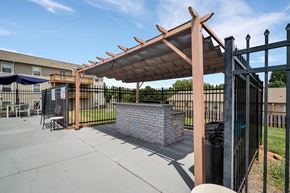 Gastonia apartment for rent - the clubhouse has a patio with a brick fireplace and a gazebo